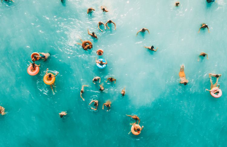 summer slogans - overhead view of people in ocean with tubes