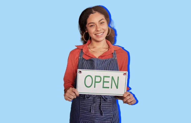 Small Business Saturday - woman in apron holding open sign