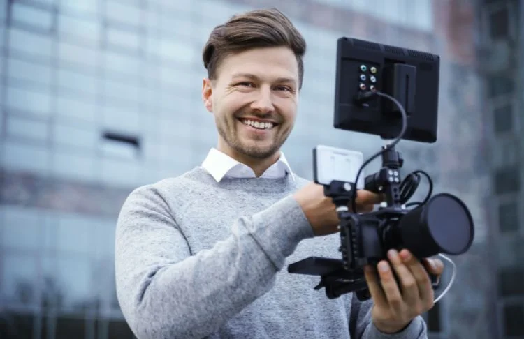 video marketing SEO - Photographer holds camera.