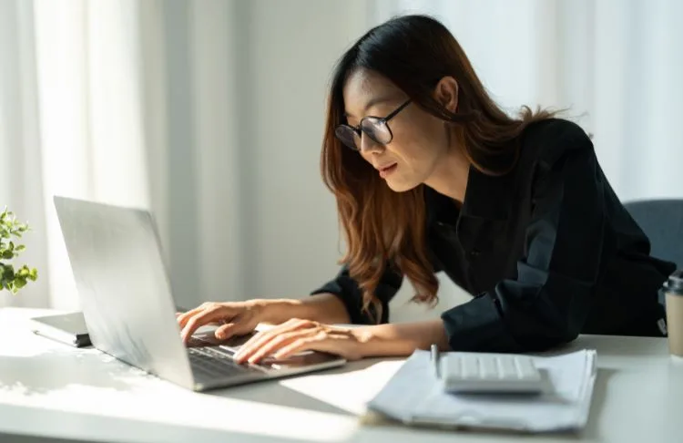 female business owner typing on computer