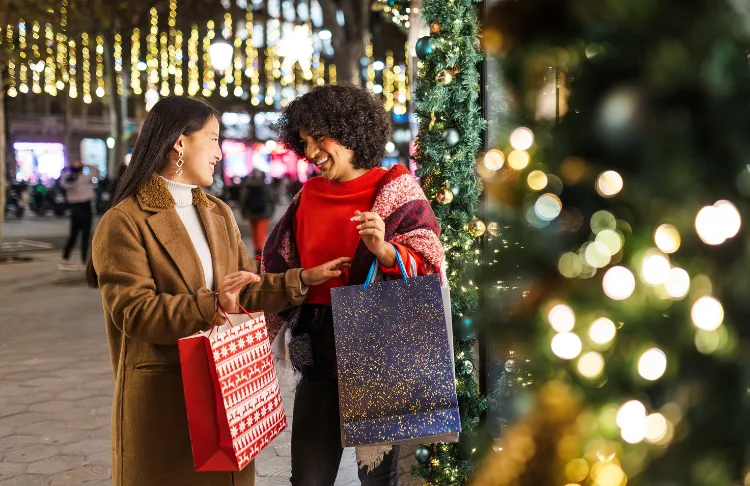 Christmas slogans - Two people with shopping bags at Chrstimas.