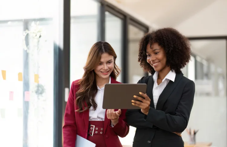 SMB SEO insights - two people reviewing a tablet.