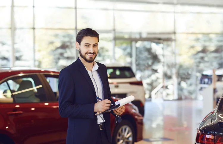 Automotive search advertising benchmarks car salesperson in the showroom.