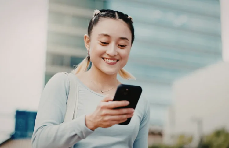 Facebook marketing - woman looks at phone.
