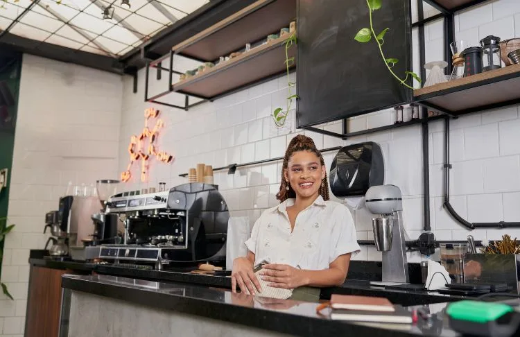 business owner at counter looking at customers