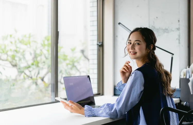 Market segment examples - woman sits at computer.