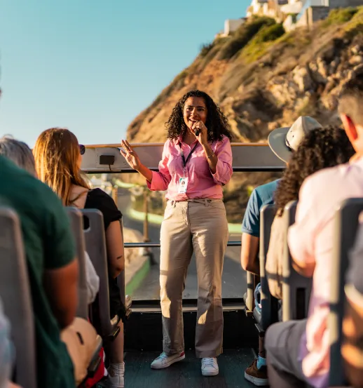 woman leads tour on bus